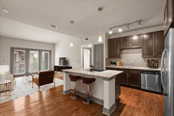 A modern kitchen with a bar area and a dining table.